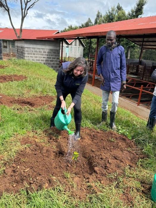 Anne Marie Butler planting a tree in commemoration of the visit to Baraka College