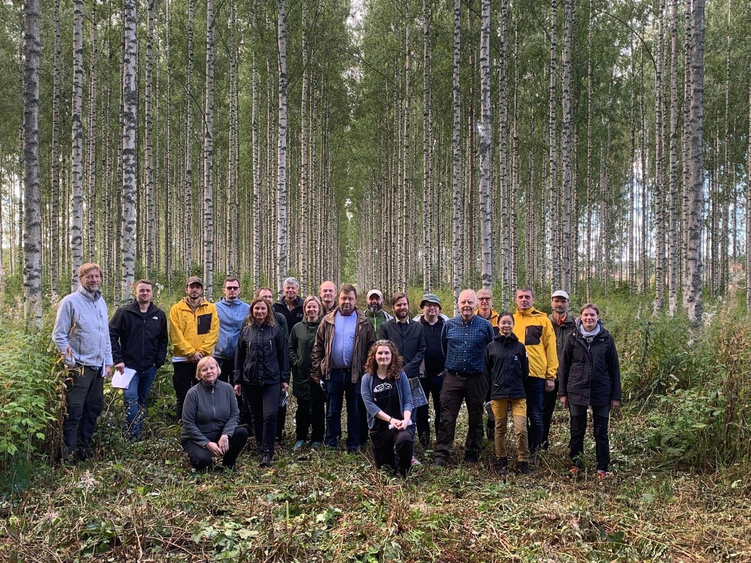 Group photo in front of a birch realised-gain demonstration