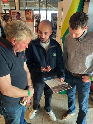 Neil Tirchett discussing pig welfare with farmers at a conference