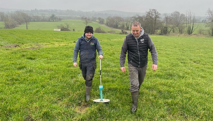 Michael Murphy and Liam Ryan measuring grass