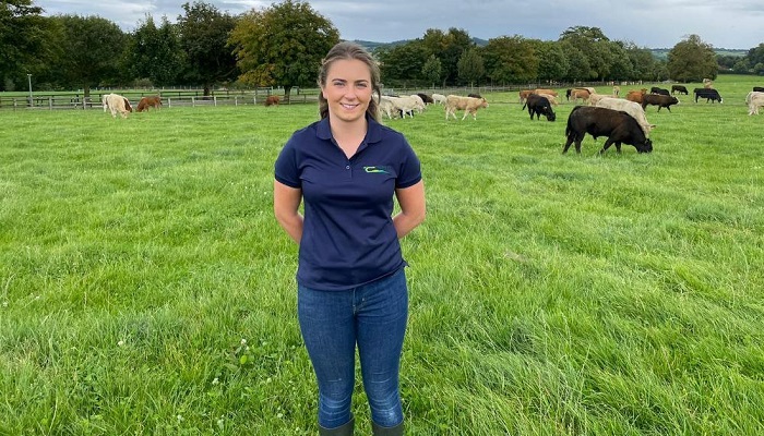 Noeleen Brereton pictured in a grass field in front of cattle