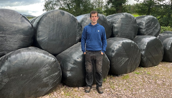 Shane Cranny DairyBeef 500 farmer pictured in front of silage bales