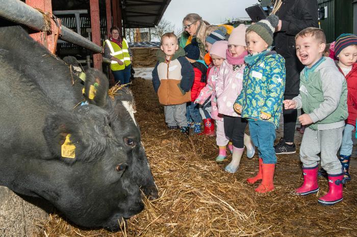 Children enjoying a tour of the farm. Children smiling.