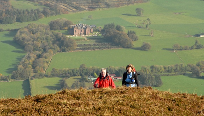 Walkers enjoying the spring air and clear views on teh Ballyhoura Mountains with Caslteoliver in the Background