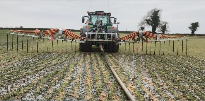pig slurry being spread on winter wheat