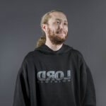 A headshot of Alex Shenfield