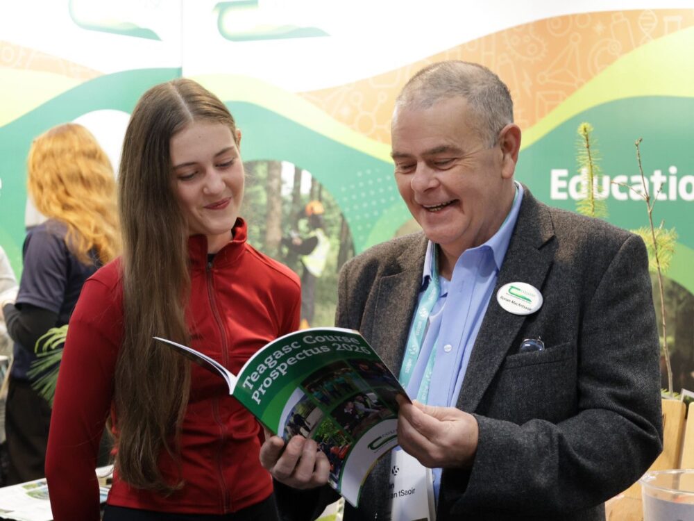 Rónán mac an tSaoir pictured speaking to a student at the Young Scientist event