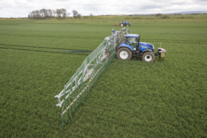 tractor in field with dribble bar