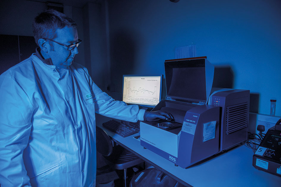 Photo of technician with a Near-Infrared Reflectance spectroscopy machine