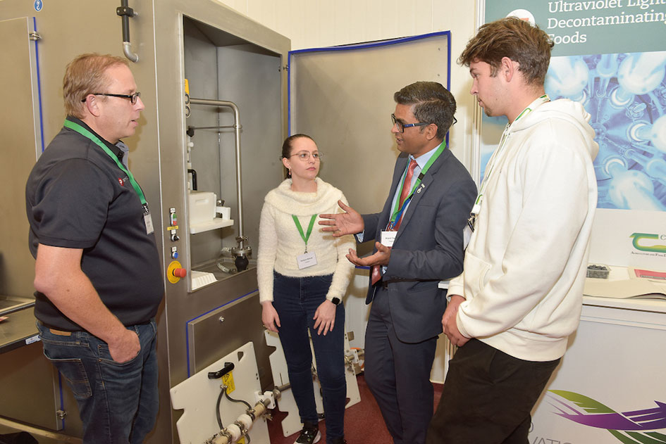Photo of Bryan Meyer (Food Physics), Barbara Biduski (Teagasc), Brijesh Tiwari (Teagasc) and Mateo Grenier (Unilasalle Rouen) discussing Pulsed Electric Field tech