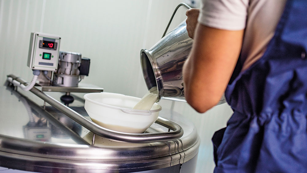 Photo of a technician pouring milk into a machine