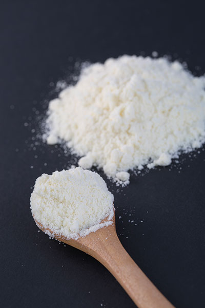 Photo of milk powder on a spoon
