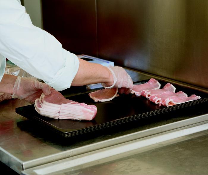 An image of rashers being put on a tray