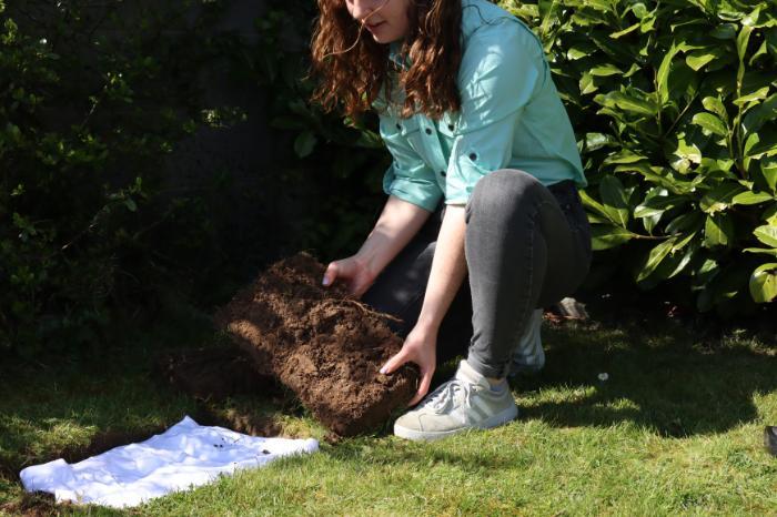 Person carrying out test for GrountTruth Project by digging a small hole in their garden