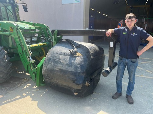 Jonathan Banville with a wrapped bale handler