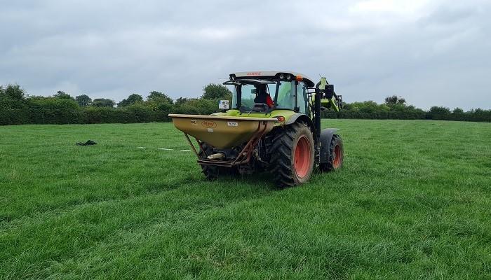 Phosphorus being spread on grass