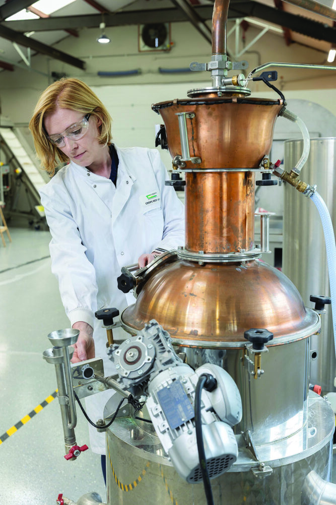Lisa works a machine in the brewing and distilling centre