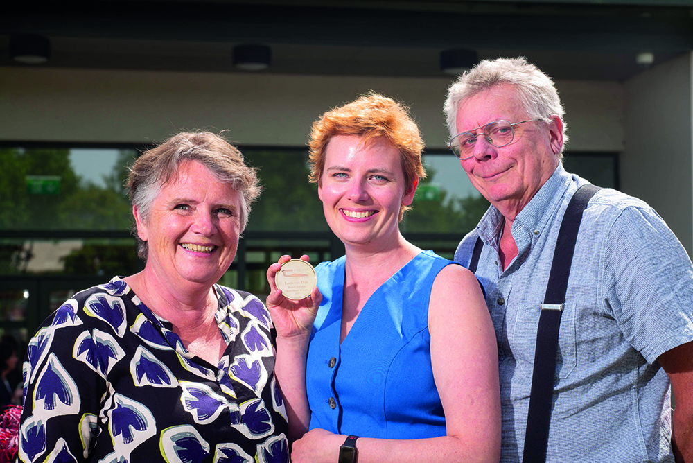 The winner and her parents smile for the camera