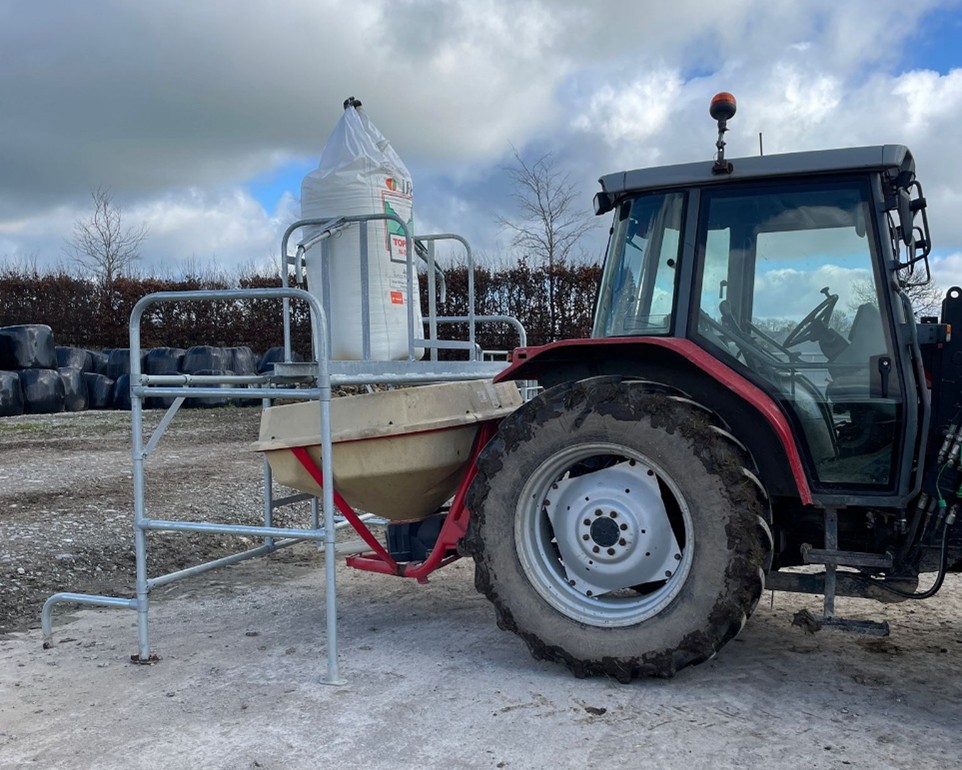 Bag of fertiliser on fertiliser stand, ready to load the fertiliser spreader on the back of a tractor