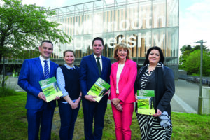 A group of 5 people standing outside Maynooth University