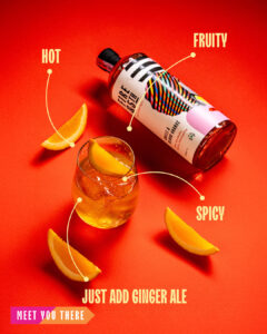 a bottle laying flat. The label reads; Chilli & blood Orange flavour