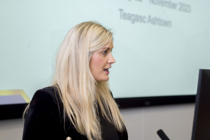 Erin O'Rourke giving a speech at a Walsh Scholars event.