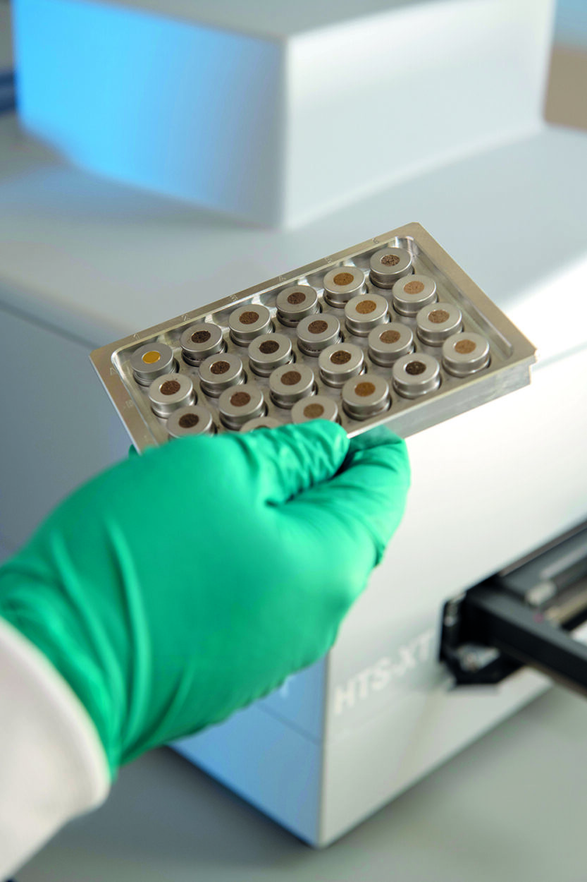 A close up of soil samples being held by a laboratory technician