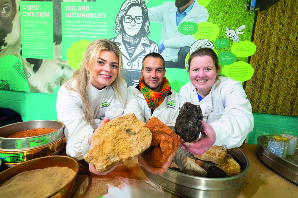 Three scientists pose for the camera at a soil workshop