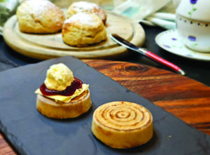 Scones with jam and cream on a wooden table