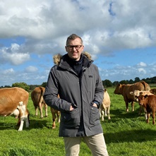 Cathal Irwin in field with cattle