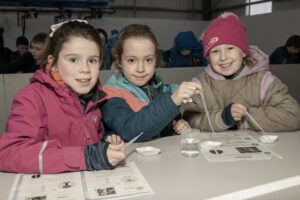 Children enjoying science experiments in the b during Science Week 2024