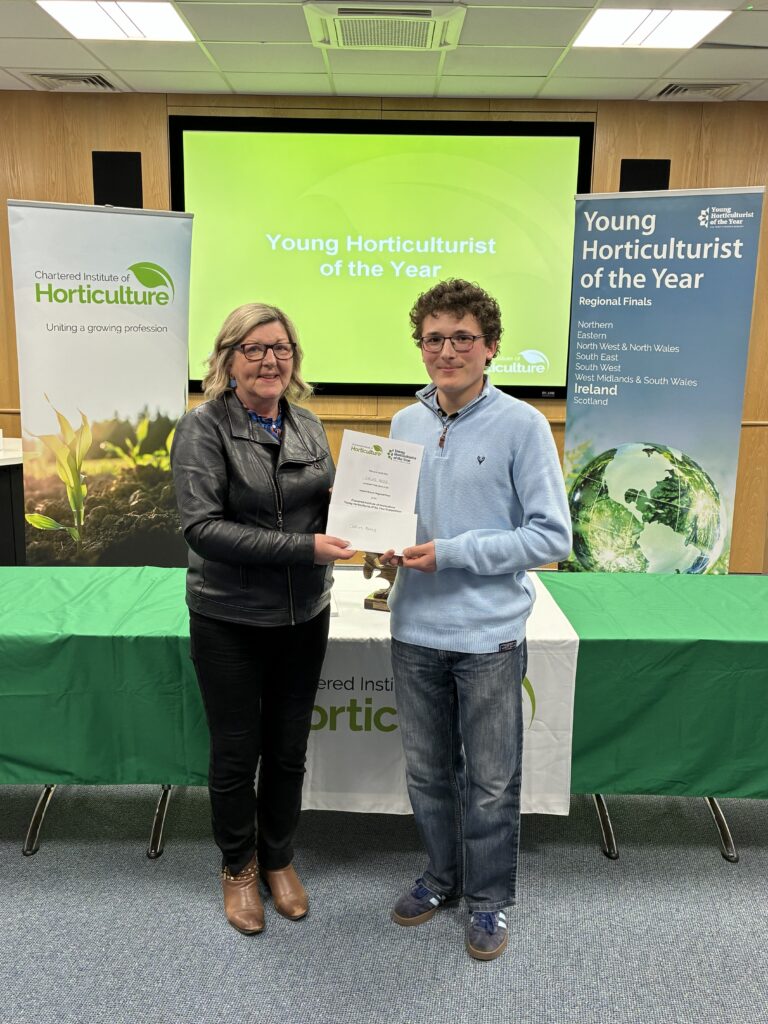 Image of student being presented Certificate for winning YHOY regional final