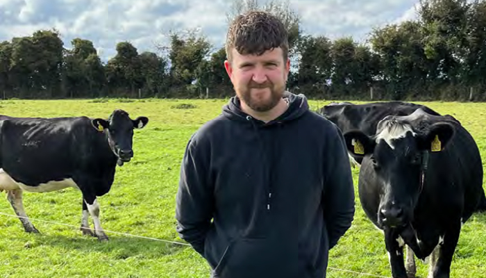 Niall O'Connell is pictured in a field with cows