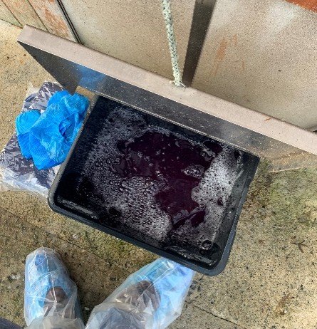Photo of a foot dip at the entrance to a bird house